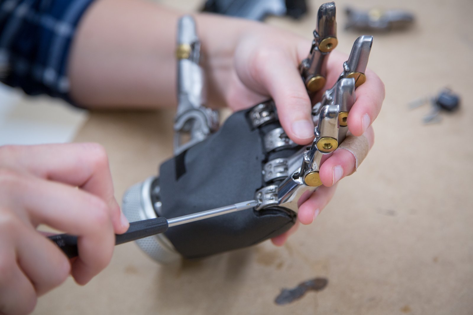 Lab member assembling 3D printed prosthetic fingers