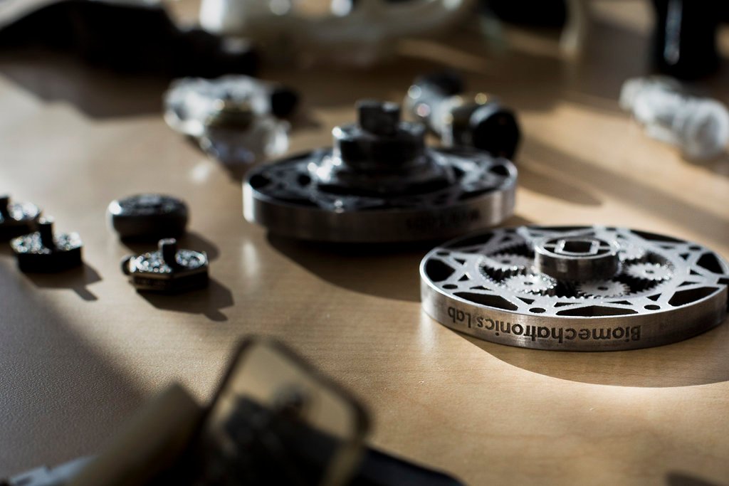 Metal 3D printed gears laying on a table.